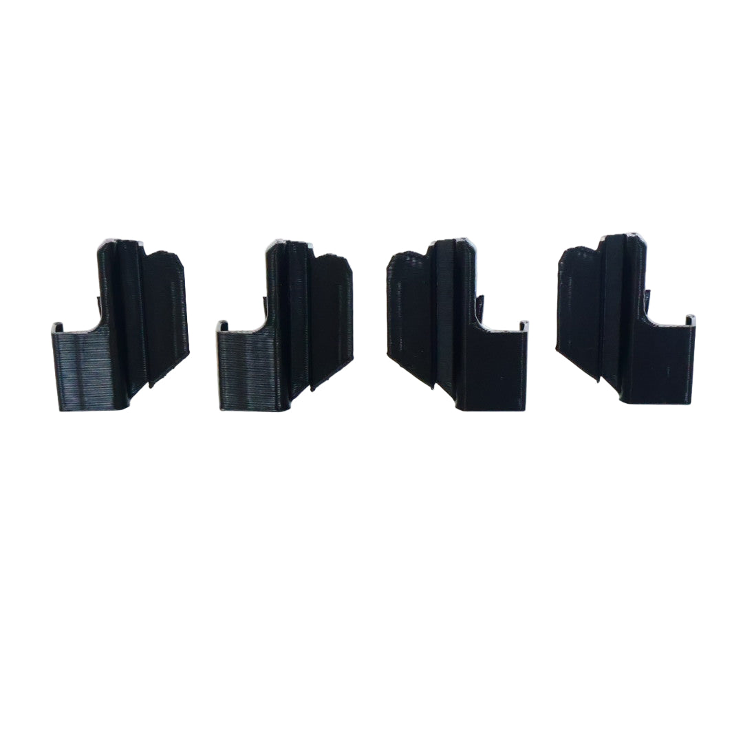Four black plastic clips on a white background