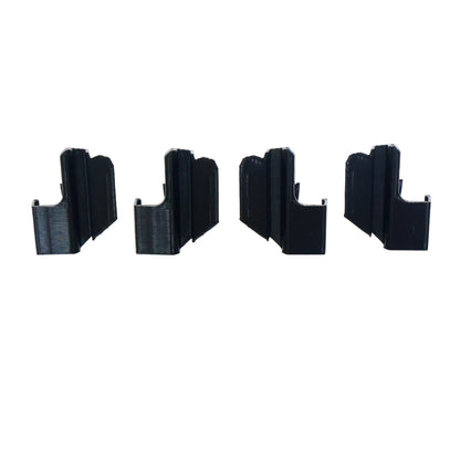 Four black plastic clips on a white background